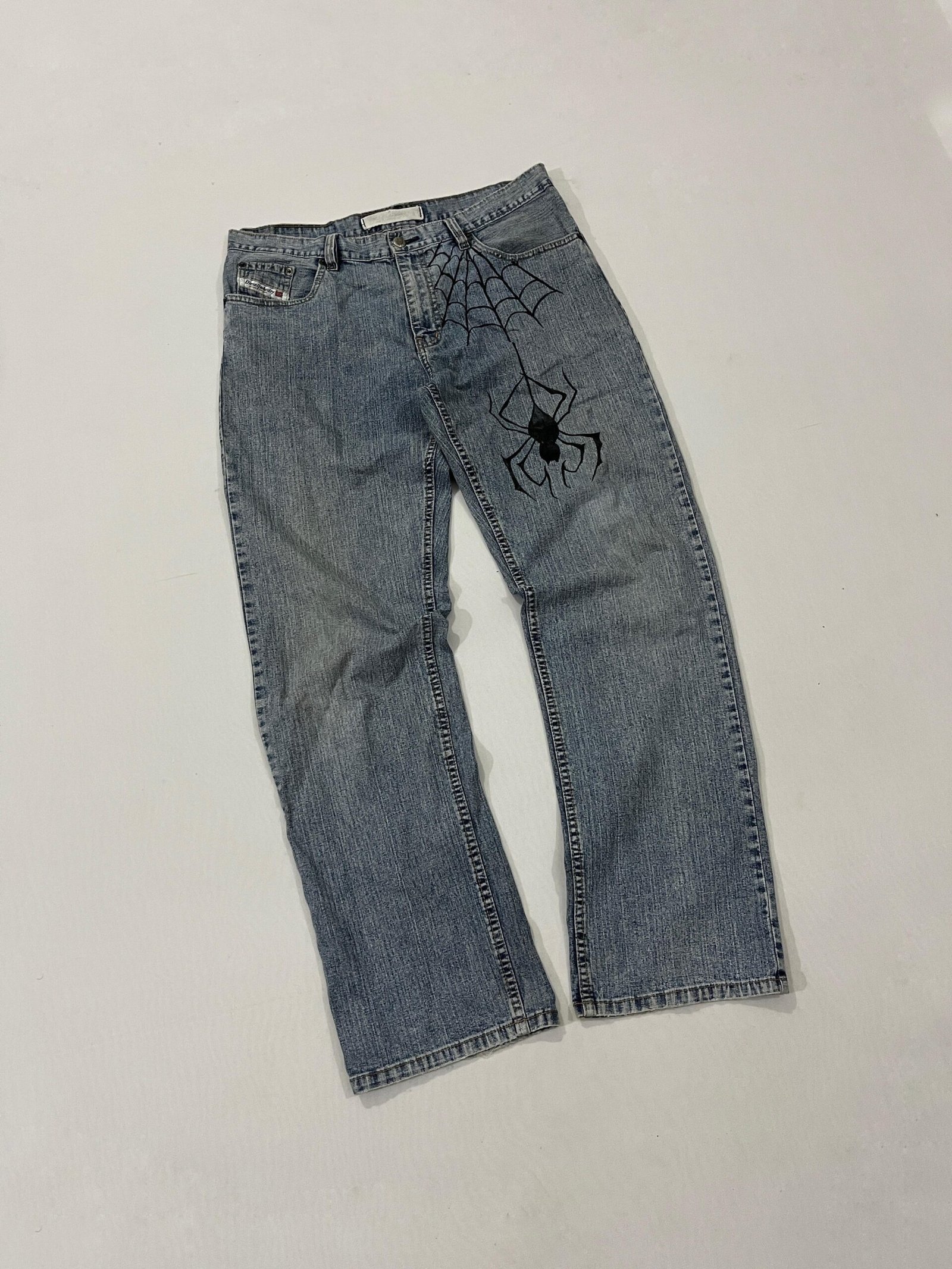 Diesel (Diesel Industry Denim Hand-painted black Spider & Web graphic running down the left front hip and thigh (gothic / Y2K streetwear motif)